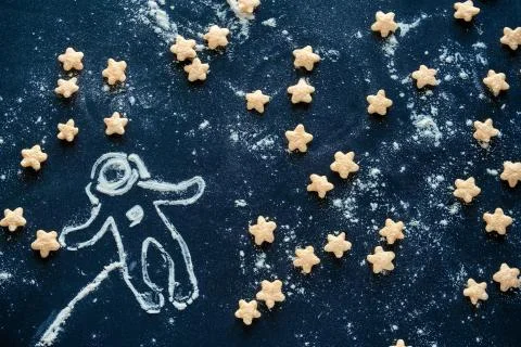 Top view flat  corn pads in the shape of stars and a silhouette of an astrona Stock Photos