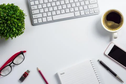 Top view, flat design office desk with computer keyboard, coffee cup, smart p Stock Photos
