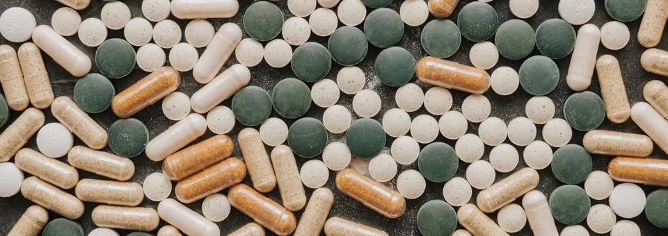 Top view flat lay background of various green chlorella pills and herbal ca.. Stock Photos