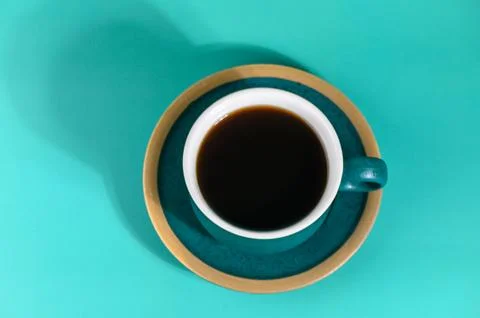 Top View Flat Lay of Black Coffee in Teal Cup and Saucer Stock Photos