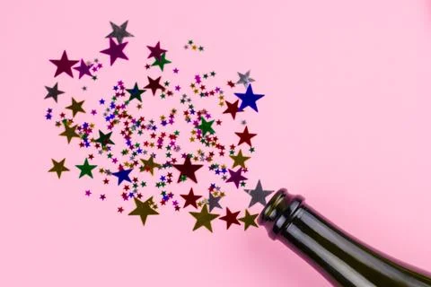 Top view flat lay bottle with christmas decoration from confetti stars Stock Photos
