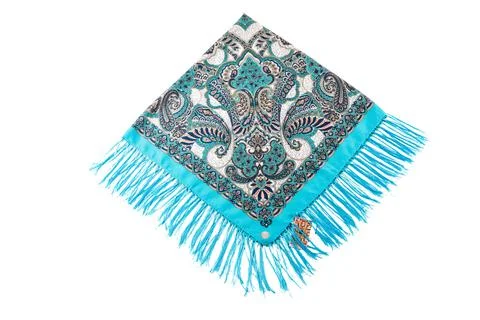 Top view flat lay on bright blue cotton scarf with fringe and bright paisley Stock Photos