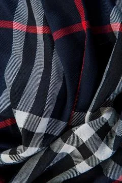 Top view flat lay closeup part of folded dark blue checked scarf Stock Photos
