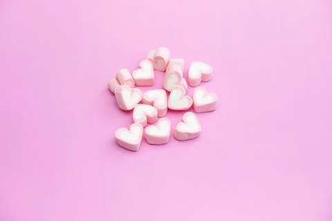 Top view flat lay design of pastel pink color marshmallows on pink background Stock-Fotos