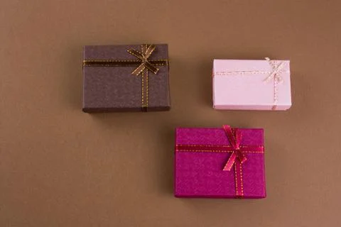 Top view flat lay gift boxes on a brown background Stock Photos