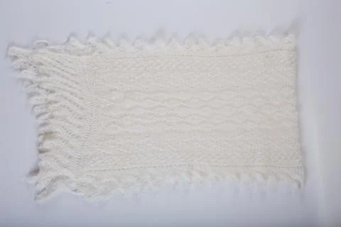 Top view on flat lay handmade white woolen scarf with knitted pattern Stock Photos