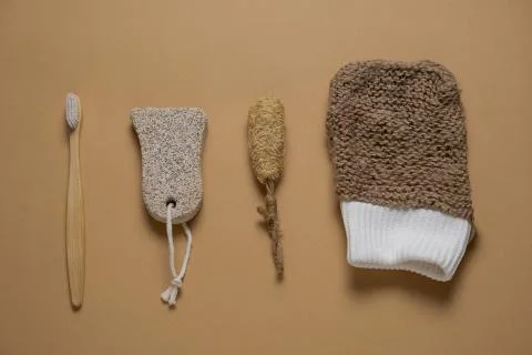 Top view flat lay jute washcloth, loofah face sponge, bamboo toooth brush  an Stock Photos