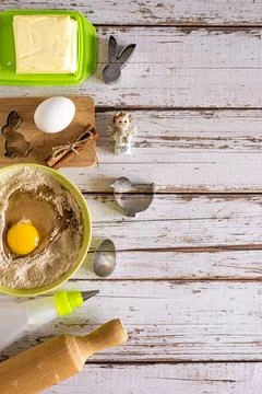 Top view flat lay kitchenware on Easter cookie baking ingredients, wooden blu Stock Photos