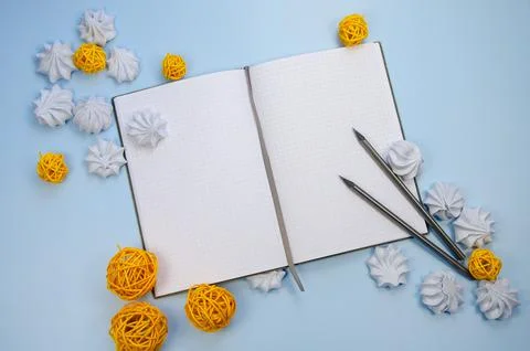 Top view flat lay macarons Opened blank notebook mockup blank pages, dark pen Stock Photos