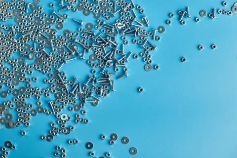 Top view, flat lay Metal screw, nuts and bolts on blue background, Stock Photos