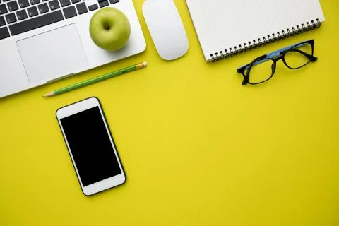 Top view, flat lay of Modern yellow office desk table with laptop Stock Photos