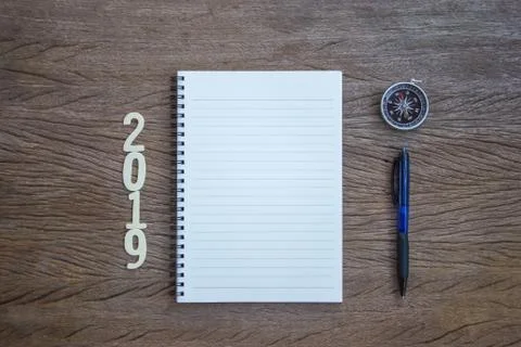 Top view, flat lay office supply note book, pen and compass with a cut wood n Stock Photos