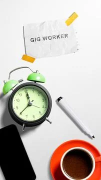 Top view flat lay of an office desk with a coffee cup, alarm clock, smartph.. Stock Photos