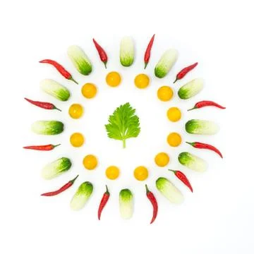 Top view flat lay over cucumbers, cherry tomatoes, celery and pepper on a whi Stock Photos