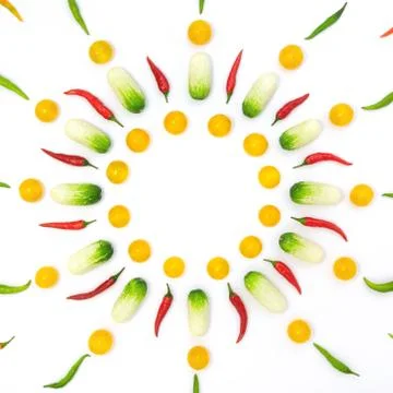 Top view flat lay over cucumbers, cherry tomatoes and peppers on a white back Stock Photos