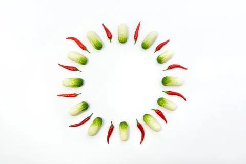 Top view flat lay over cucumbers and peppers on a white background with copy  Stock Photos