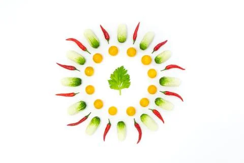 Top view flat lay over cucumbers, cherry tomatoes, celery and pepper on a whi Stock Photos