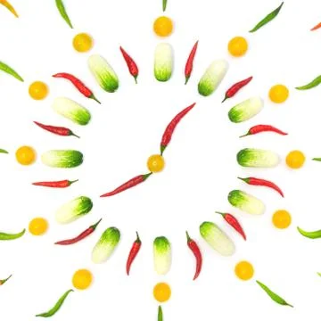 Top view flat lay over vegetables laid out in the form of a clock on a white Stock Photos