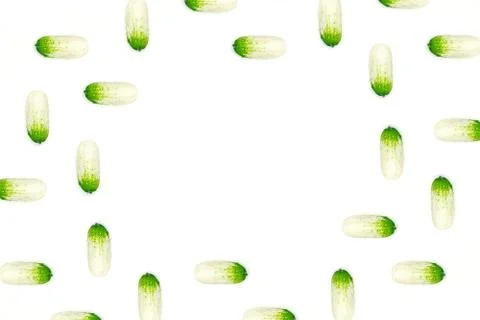 Top view of a flat lay over cucumbers with a geometric pattern on a white bac Stock Photos