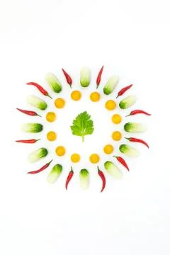 Top view flat lay over cucumbers, cherry tomatoes, celery and pepper on a whi Stock Photos