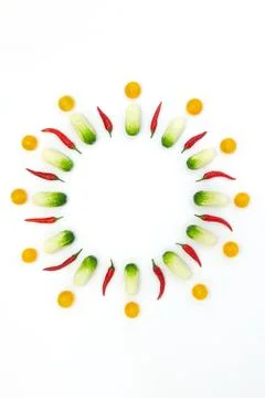 Top view flat lay over cucumbers, cherry tomatoes and peppers on a white back Stock Photos