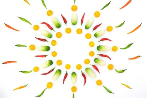 Top view flat lay over cucumbers, cherry tomatoes and peppers on a white back Stock Photos