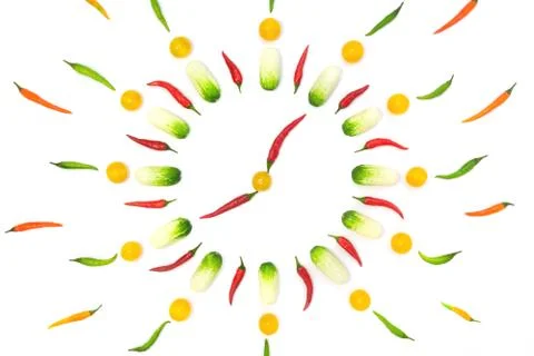 Top view flat lay over vegetables laid out in the form of a clock on a white  Stock Photos