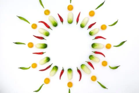 Top view flat lay over cucumbers, cherry tomatoes and peppers on a white back Stock Photos
