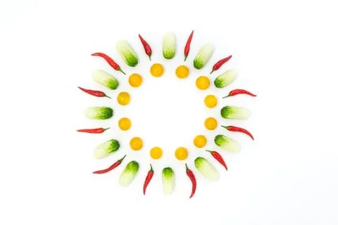 Top view flat lay over cucumbers, cherry tomatoes and peppers on a white back Stock Photos