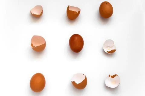Top view flat lay pattern  brown eggs and egg shells on a white background Stock Photos