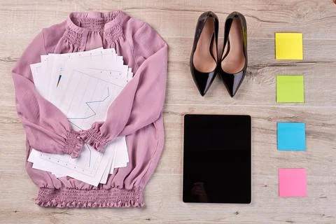 Top view flat lay pink blouse with work papers and shoes. Foto stock