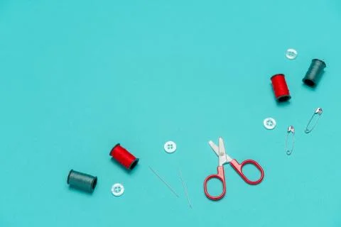 Top view flat lay red and blue sewing or embroidery supplies on a blue backgr Stock Photos