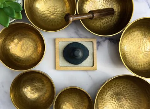 Top View Flat Lay of Singing Bowls and Zen Stones in Meditation Arrangement Stock Photos