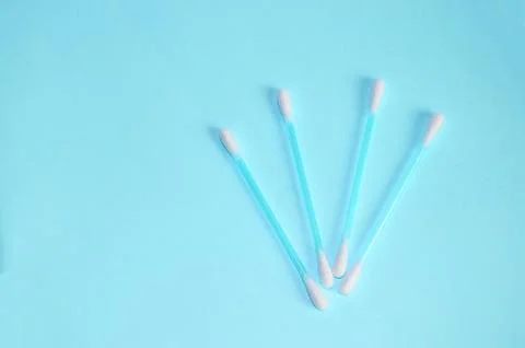 Top view, flat lay, a small group of pink plastic cotton swabs neatly arrange Stock Photos
