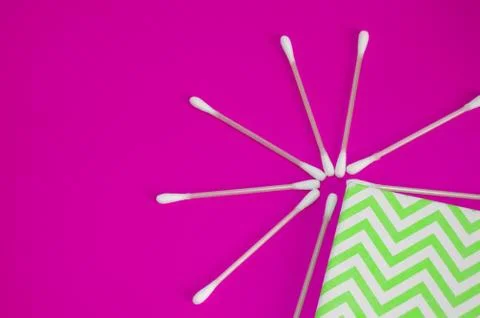 Top view, flat lay, a small group of pink plastic cotton swabs neatly arrange Stock Photos