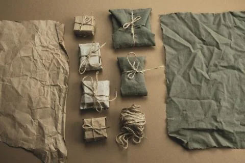 Top view flat lay textile and craft paper gift boxes on a brown background 스톡 사진