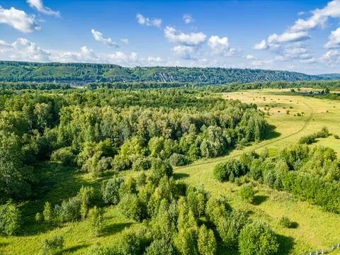 Top view of flat terrain with forests and meadows Stock Photos