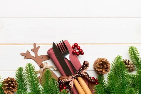 Top view of flatware tied up with ribbon on napkin on wooden background. Ch.. Stock Photos