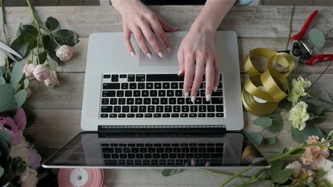 Top view florist table with laptop, flower shop workplace, Laptop, beautiful Stock Footage
