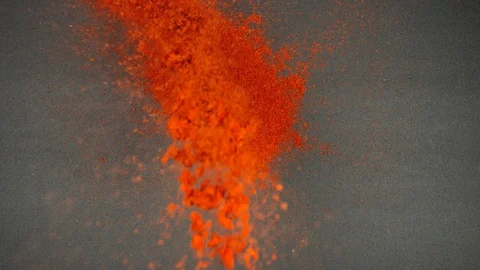 TOP VIEW: Flow of red pepper falls on a black table - Slow Motion Stock Footage 90240075