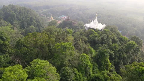 Top view of fly over old pagoda on mountain in Thailand with green forest Stock Footage 142081096
