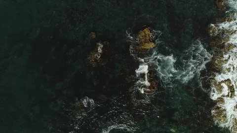 Top view flying over stormy sea wave turquoise water hitting on natural stone Stock Footage 127846802