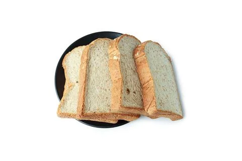 Top view focus of pile of toasted bread slices on a single black plate. On pu Foto stock