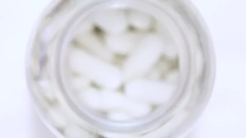 Top view focus pull on white medical pills in plastic bottle Stock-Footage 334732154