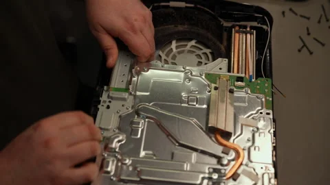 Top view of focused technician working with disassembling game console Stock Footage 310624913