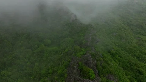 Top view fog flows over the rocky mountain landscape, aerial view Video stock 249999227
