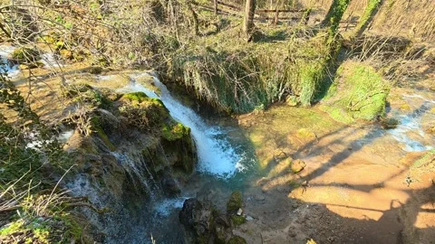 Top View of Forest Waterfall Flowing Away – Slow Pan Right Vídeo Stock 330676947