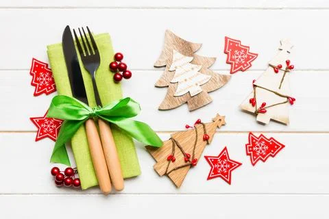 Top view of fork and knife tied up with ribbon on napkin on wooden background Stock Photos