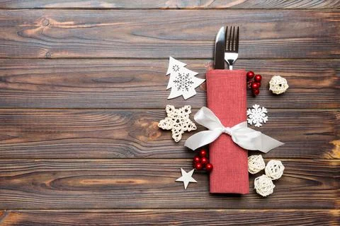 Top view of fork and knife on napkin on wooden background. Different christ.. Stock Photos