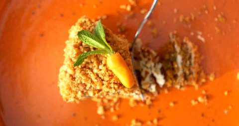 Top view of fork cutting carrot cake with mint and miniature carrot Stock-Footage 343424847